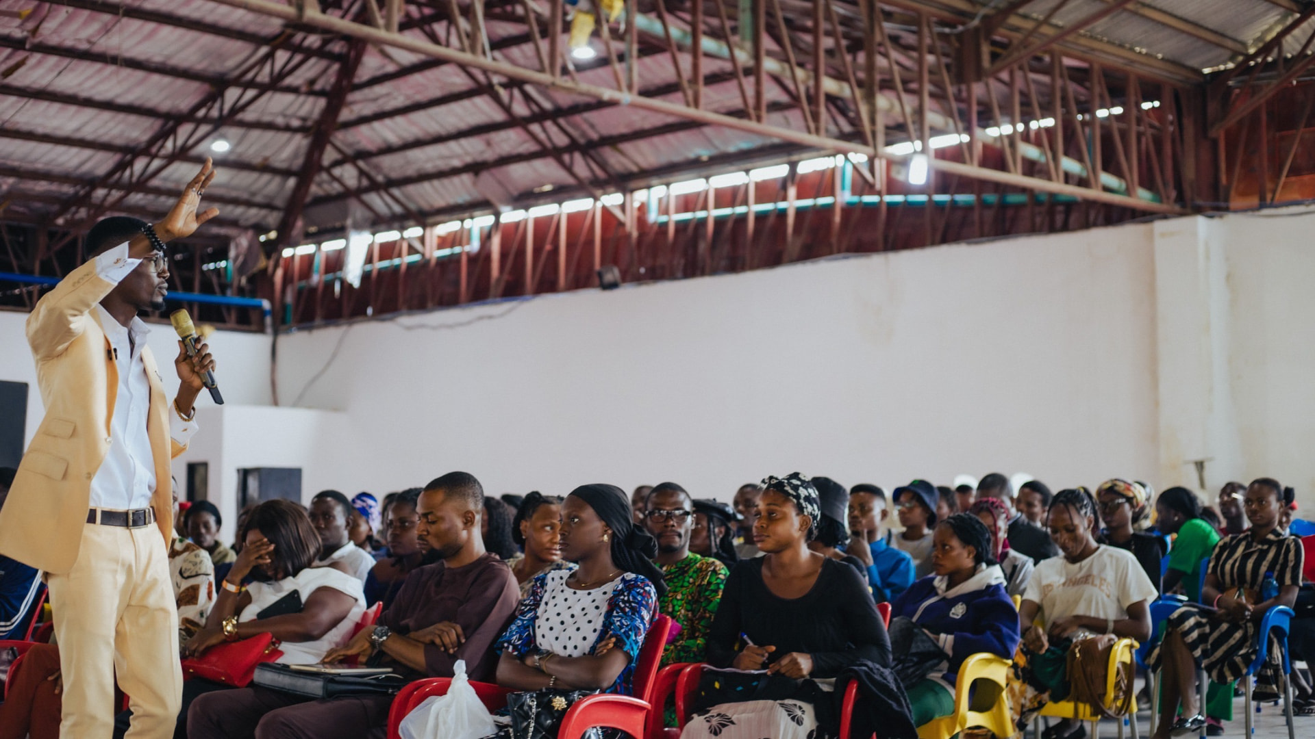 Prince Oluwatosin Odumosu presenting to a large audience during a masterclass